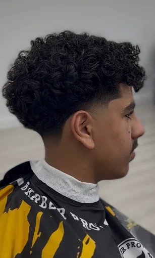 Customer profile showing a curly taper haircut