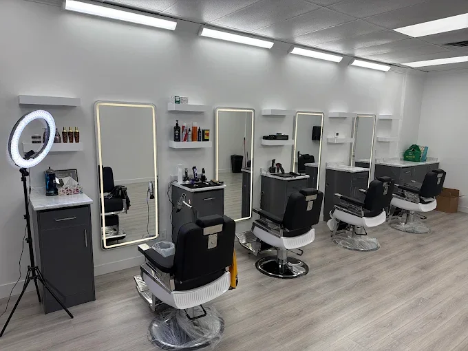 Bright Bladez Affair interior with four barber chairs and illuminated mirrors